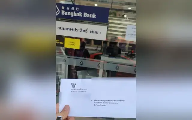 Police letter in an envelope being delivered to a Bangkok Bank branch in Pattaya, personal details hidden