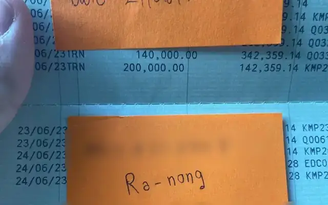 KBank passbook with a note about a police case in Ranong, personal details hidden