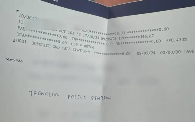 Bangkok Bank hold printout showing a police order from Thonglor Police Station, personal details hidden