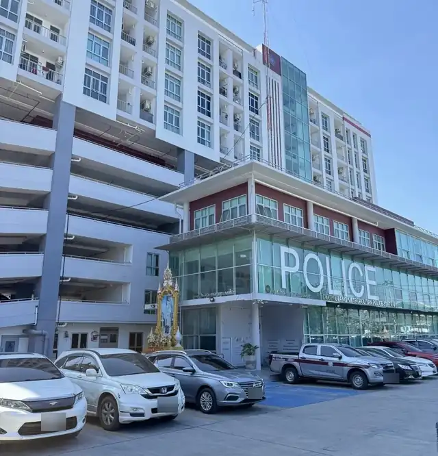 A police station in Bangkok where account holders give statements in police hold cases; car number plates are blurred