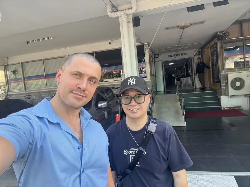 UnblockPro.Asia with a student from China outside a Bangkok police station